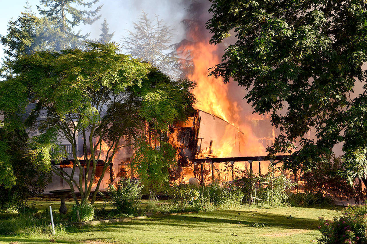 One home was destroyed and another damaged in a Thursday morning fire on Whidbey Island. (Whidbey News-Times)