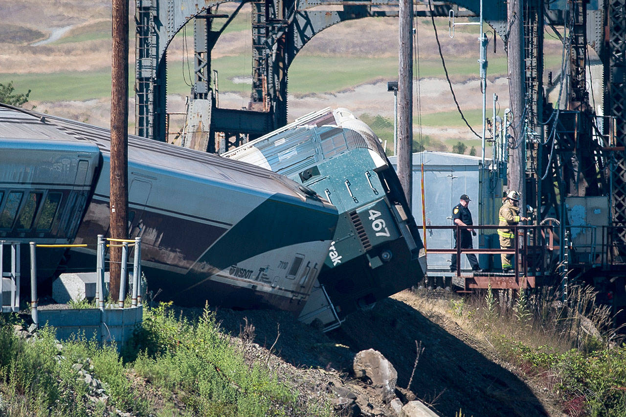 Emergency crews respond to the scene of a train derailment near Steilacoom on Sunday. Minor injuries were reported. (Joshua Bessex / The News Tribune)