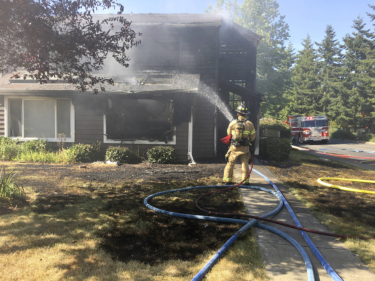 Crews douse a house fire south of Everett on Saturday. (Snohomish County Fire District 1)
