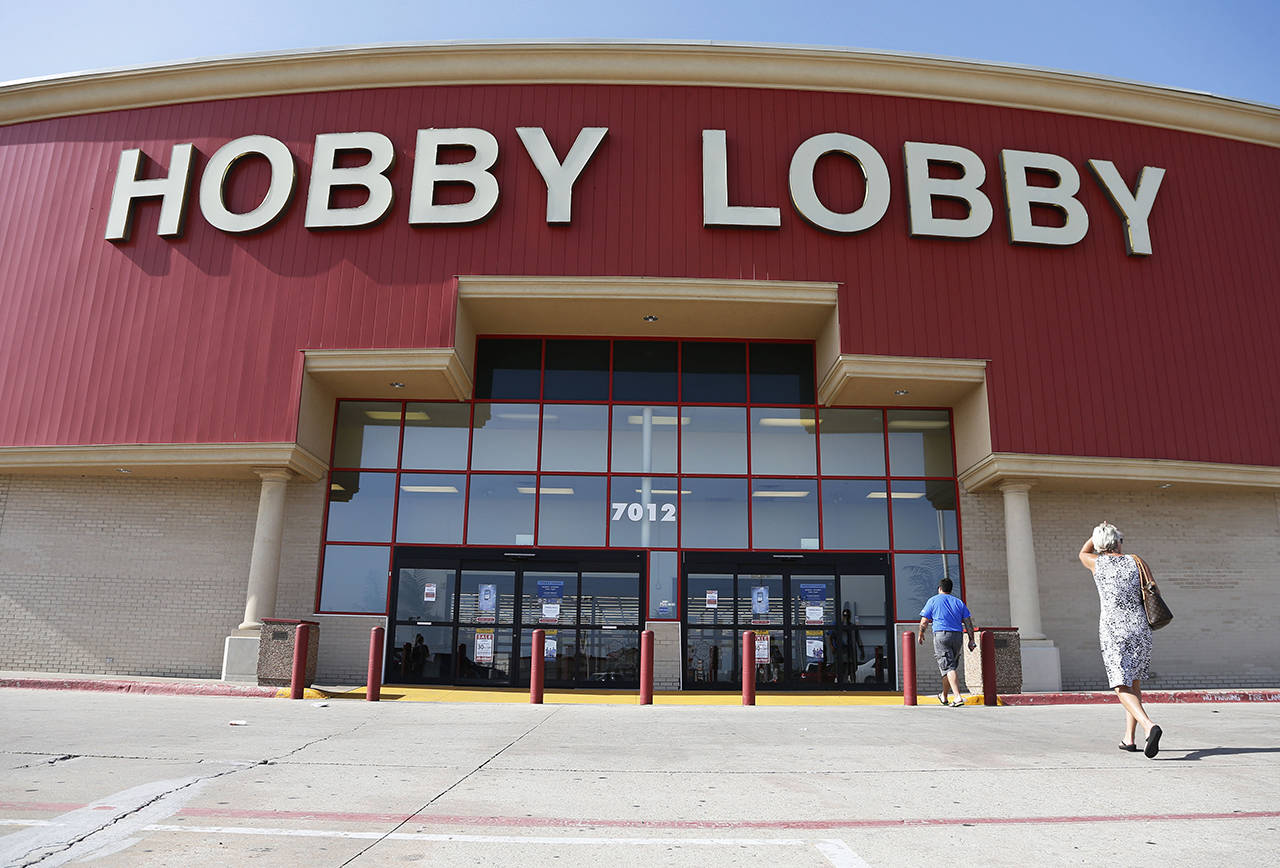 In this 2014 photo, customers walk to a Hobby Lobby store in Oklahoma City. (AP Photo/Sue Ogrocki, File)