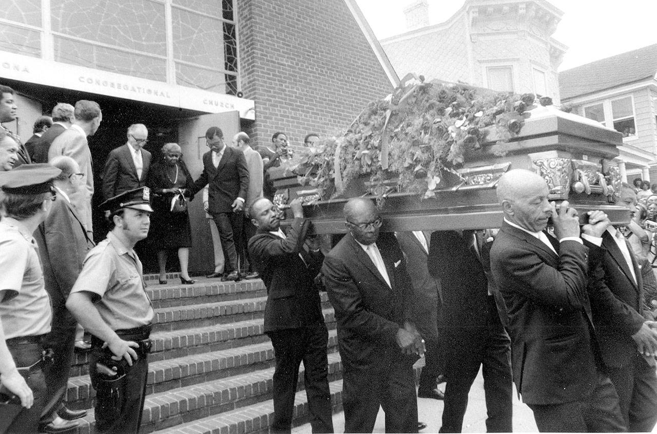 Pallbearers carry the casket of jazz musician Louis Armstrong from the Corona Congregational Church following a funeral service in the Queens borough of New York City on July 9, 1971. Walking out of the church is Armstrong’s widow, Lucille Armstrong. The music legend died three days previously. (Associated Press archive)