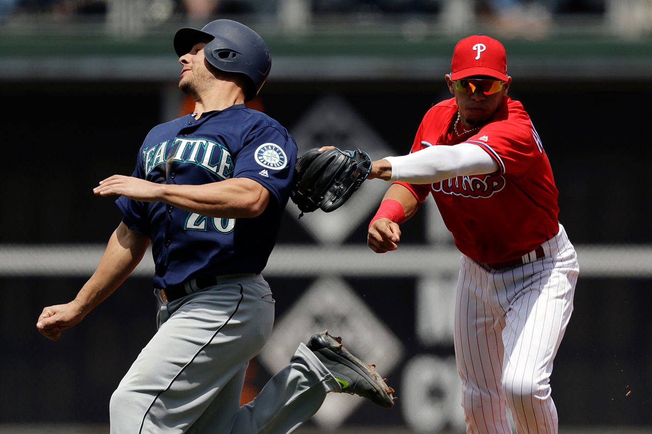 Phillies second baseman Cesar Hernandez (right) tags out the Mariners’ Danny Valencia on a fielder’s choice during the third inning of a game May 10, 2017, in Philadelphia. (AP Photo/Matt Slocum)