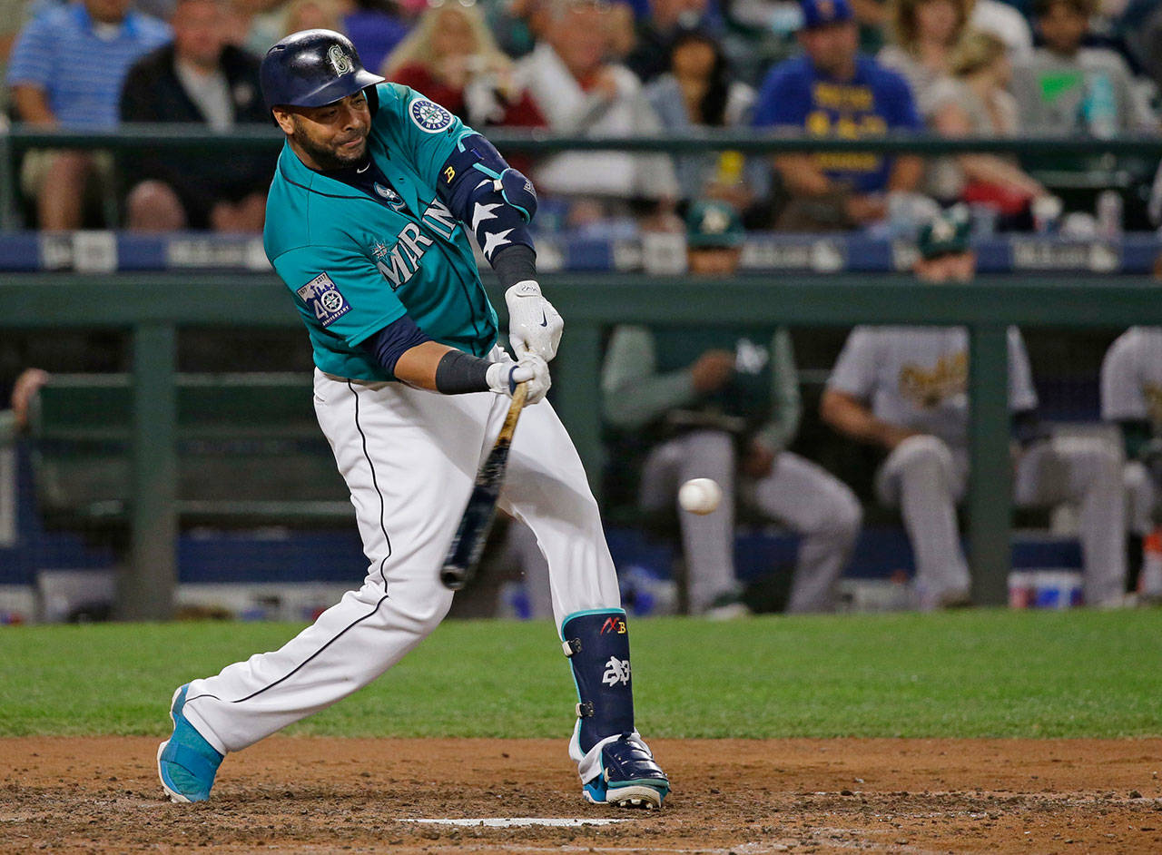 The Mariners’ Nelson Cruz hits a three-run home run during the eighth inning of a game against the Athletics on July 7, 2017, in Seattle. (AP Photo/Ted S. Warren)