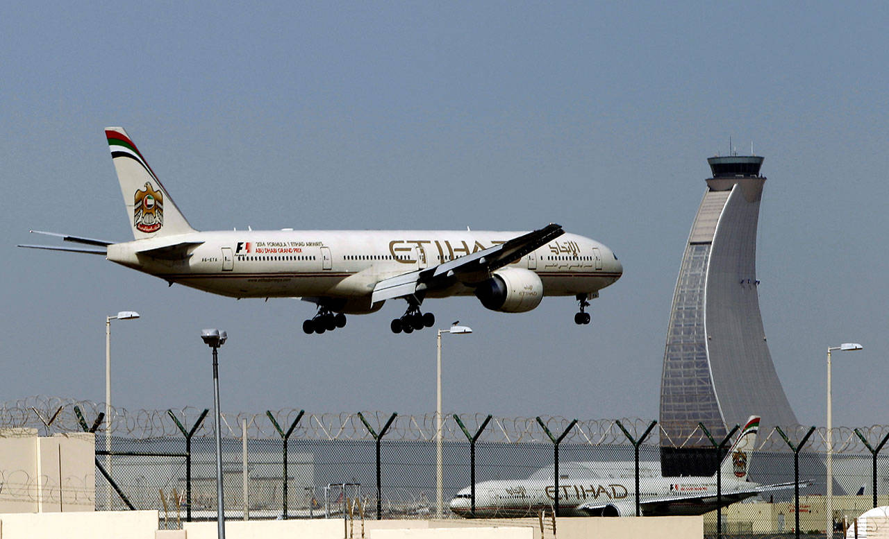 In this May 4, 2014 file photo, an Etihad Airways plane prepares to land at the Abu Dhabi airport in the United Arab Emirates. The capital of the United Arab Emirates became the first city to find itself exempt from a U.S. ban on laptop computers being in airplane cabins, the country’s flag carrier said Sunday. (AP Photo/Kamran Jebreili, File)
