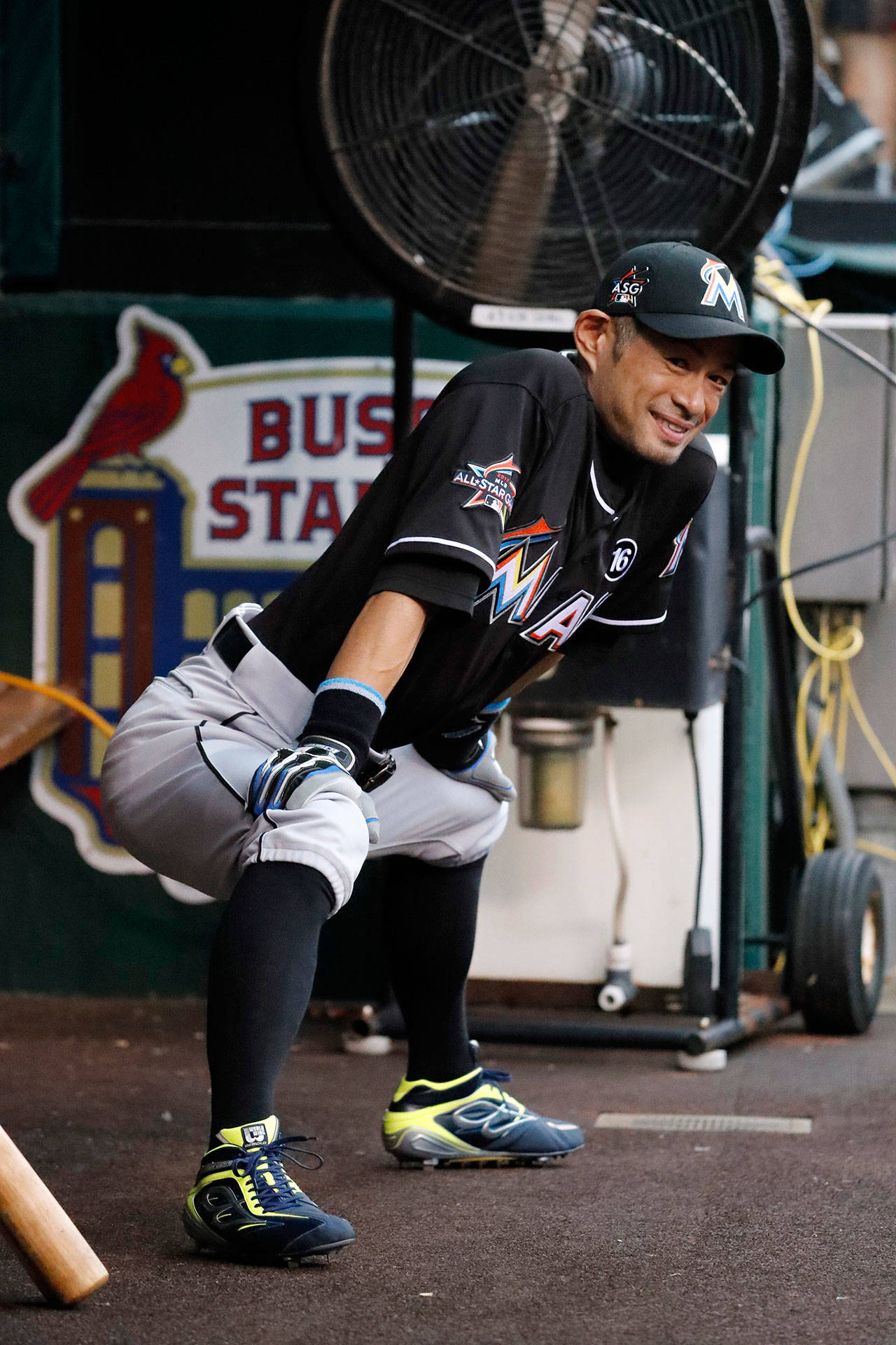 Outfielder Ichiro Suzuki of the Miami Marlins stretches in the dugout before the start of Wednesday’s game against the Cardinals in St. Louis. (AP Photo/Jeff Roberson)