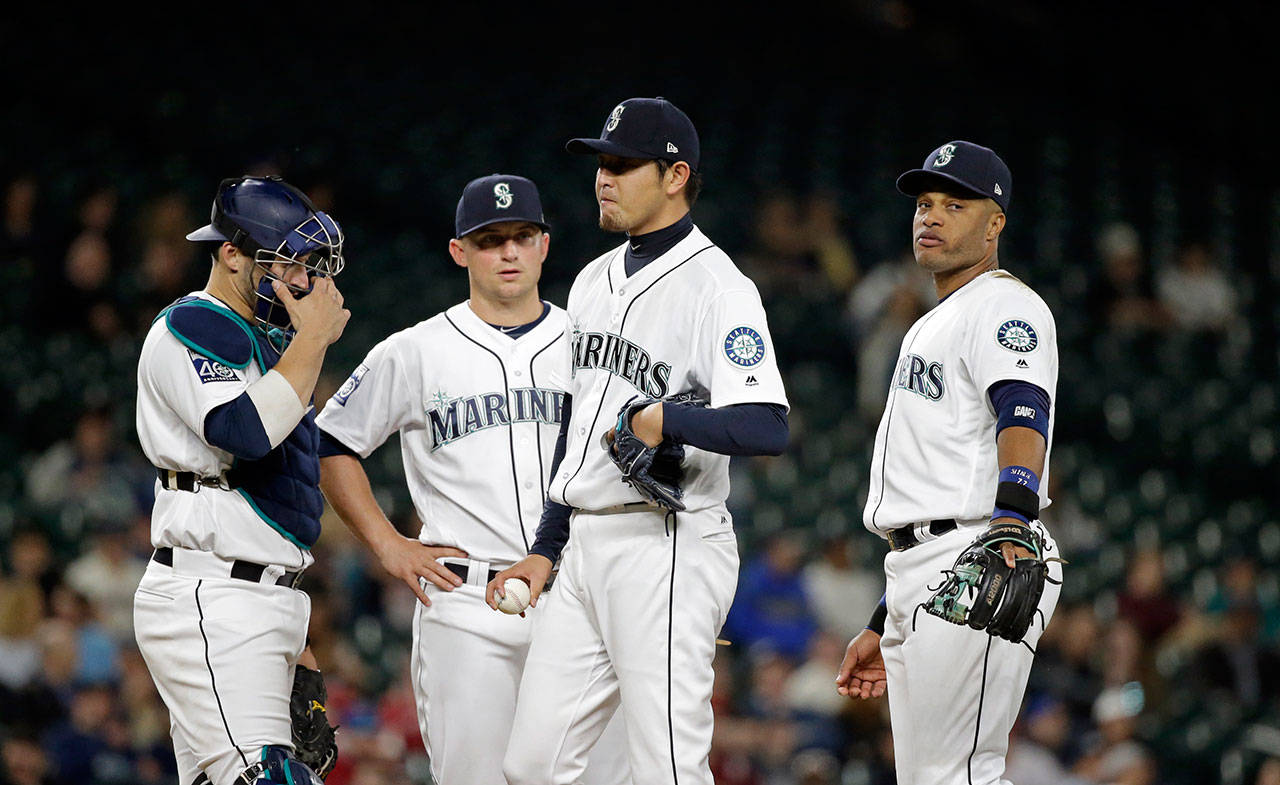 Mariners starting pitcher Hisashi Iwakuma, second right, waits with teammates to be relieved against the Angels in a game on Wednesday, May 3 in Seattle. (AP Photo/Elaine Thompson)