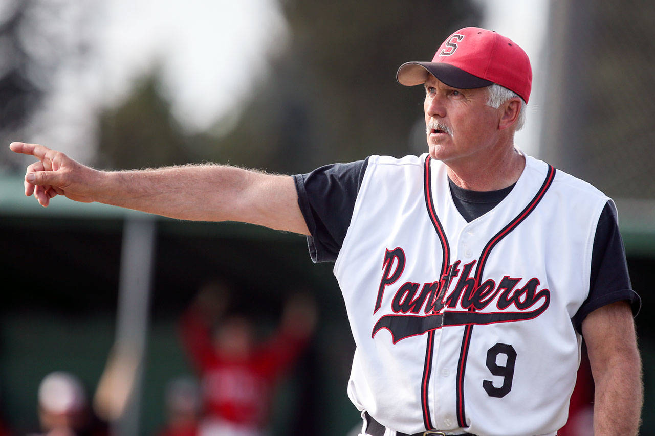 Snohomish baseball coach Kim Hammons directs the Panthers in a Wesco 3A North game against Marysville Pilchuck at Earl Torgeson Field in Snohomish on May 10. Hammons is retiring after 25 years leading the Panther program. (Kevin Clark / The Herald)