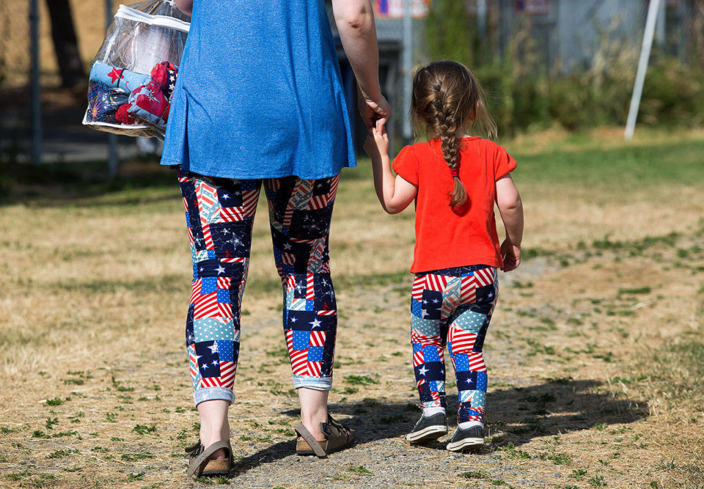 Jordan Williams and daughter Raegan sport matching patriotic leggings at the Mountlake Terrace 3rd of July event at Ballinger Park on Monday, July 3, 2017 in Mountlake Terrace, Wa. (Andy Bronson / The Herald)
