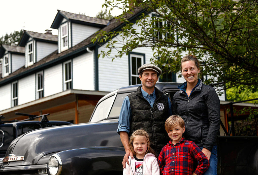 Blair and Kathy Corson and their children, William, 6, and Amelia, 4, outside the Bush House with their vintage 1952 Chevrolet pickup truck Tuesday (Dan Bates / The Herald)
