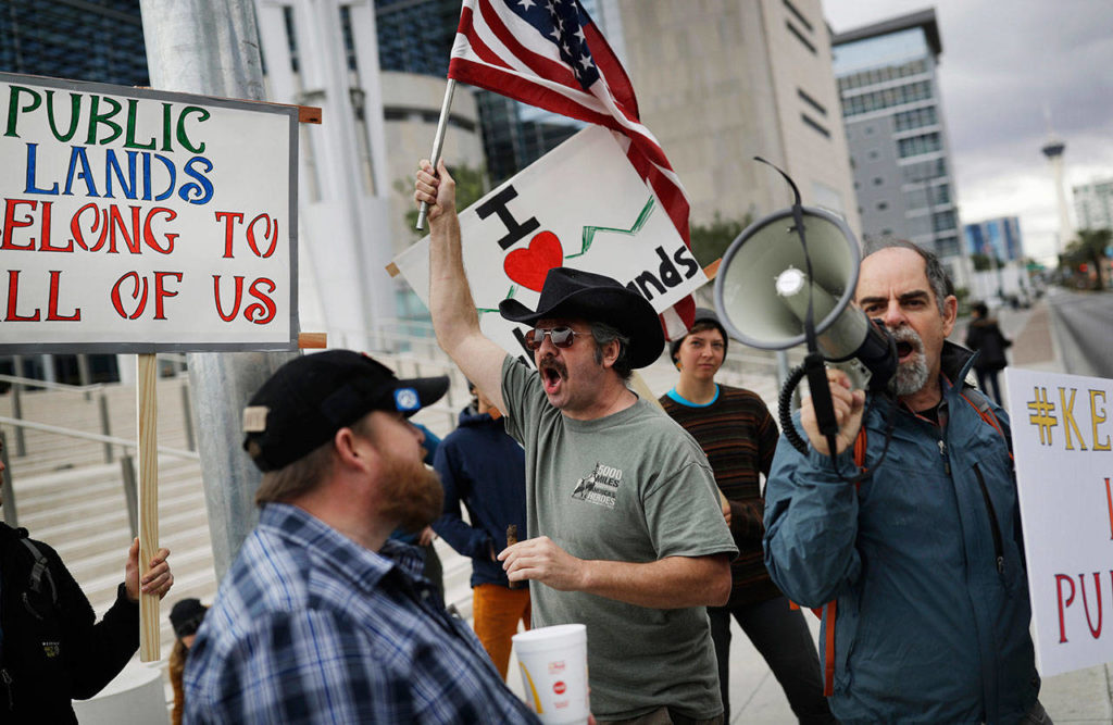 In this Feb. 6, 2017, file photo, supporters and critics of defendants on trial at the federal courthouse gather in Las Vegas. Federal prosecutors will try again to convince a jury that four men conspired with Nevada rancher Cliven Bundy and his family when they took up arms during a 2014 standoff that stopped federal agents from confiscating cows belonging to the states’ rights advocate. July selection begins Monday, July 10. (AP Photo/John Locher, FIle)
