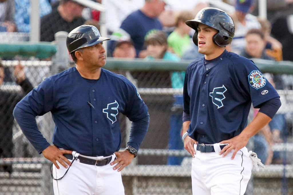 AquaSox manager Jose Moreno (left) talks with Evan White during a game against the Canadians on June 28, 2017, at Everett Memorial Stadium in Everett. (Kevin Clark / The Herald)

