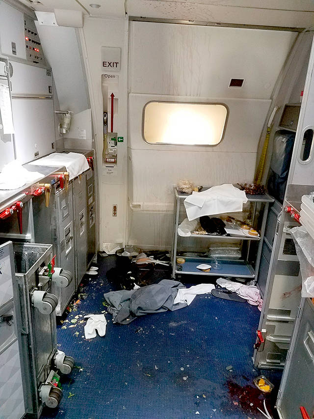 The aftermath in the cabin of Delta Flight 129 from Seattle to Beijing, after authorities say flight attendants struggled with Joseph Daniel Hudek IV, a passenger who lunged for an exit door. The photo was included in a criminal complaint filed Friday. (FBI via U.S. Attorney’s Office in Seattle via AP)