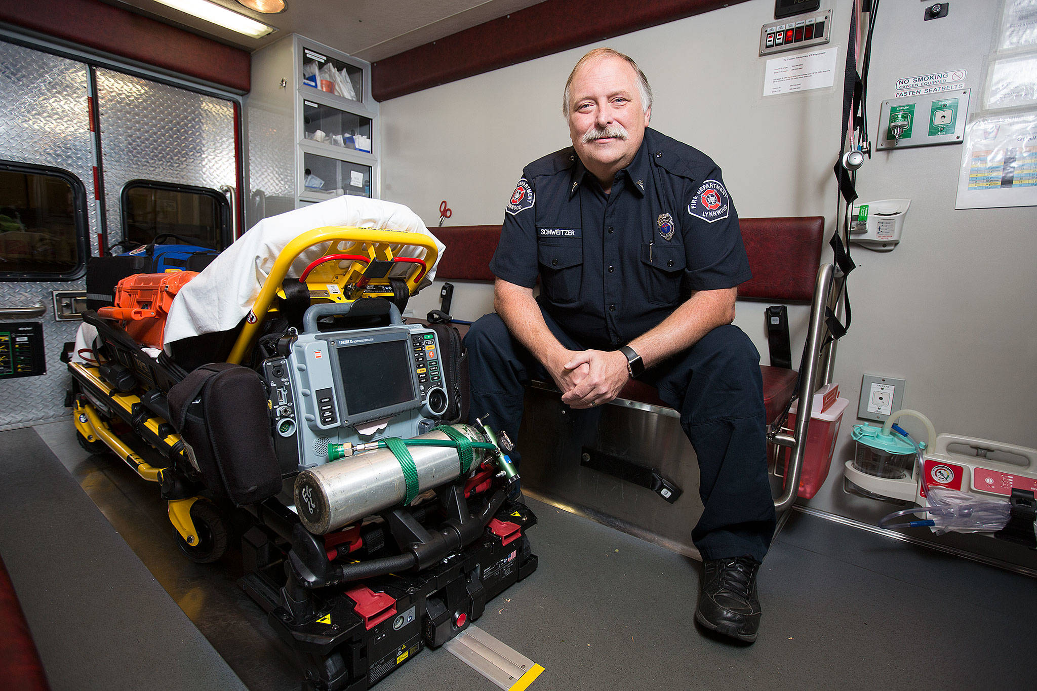Lynnwood Fire Department paramedic Vincent Schweitzer, 61, poses in the paramedic unit at Station 15 on July 27 in Lynnwood. Schweitzer is the last paramedic still on the job from a starting group of seven in south Snohomish County. (Andy Bronson / The Herald)