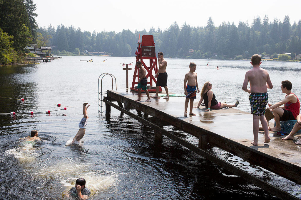 Campers dive into the lake after missing a Disney trivia question, the week’s theme, while at Camp Killoqua on Aug. 2 in Stanwood. (Andy Bronson / The Herald)
