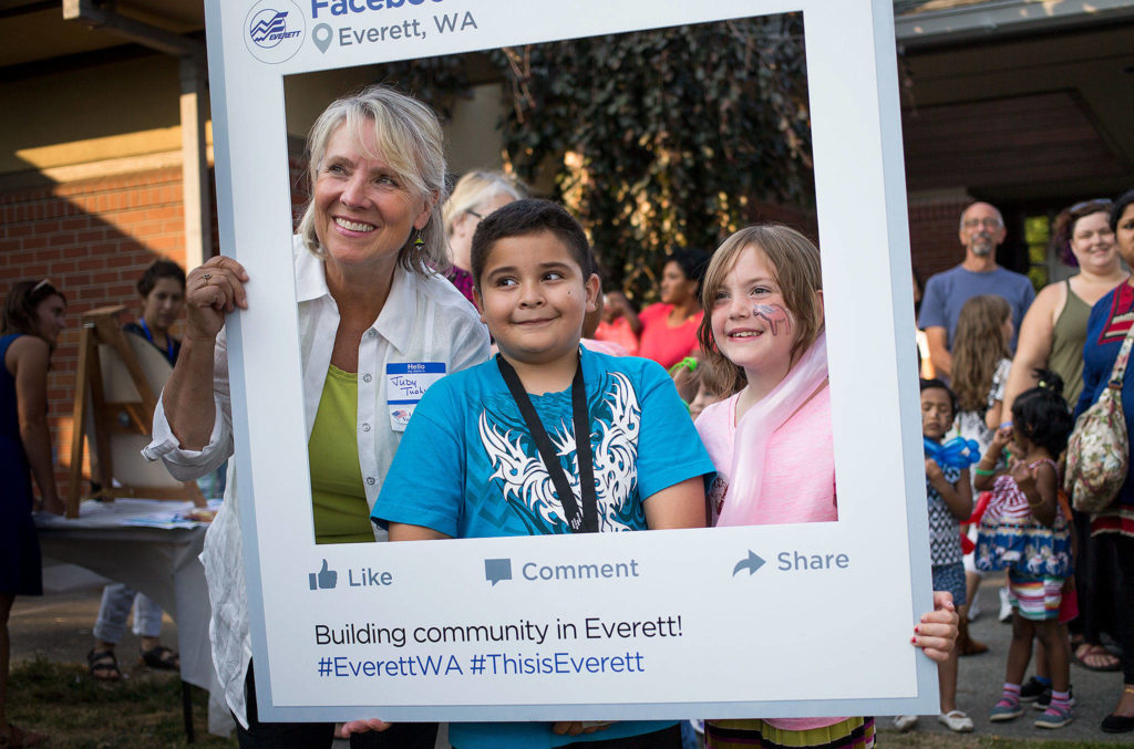 Mayoral candidate Judy Tuohy poses for a photo with kids at a National Night Out event at the Evergreen Branch Library on Tuesday in Everett. (Andy Bronson / The Herald)
