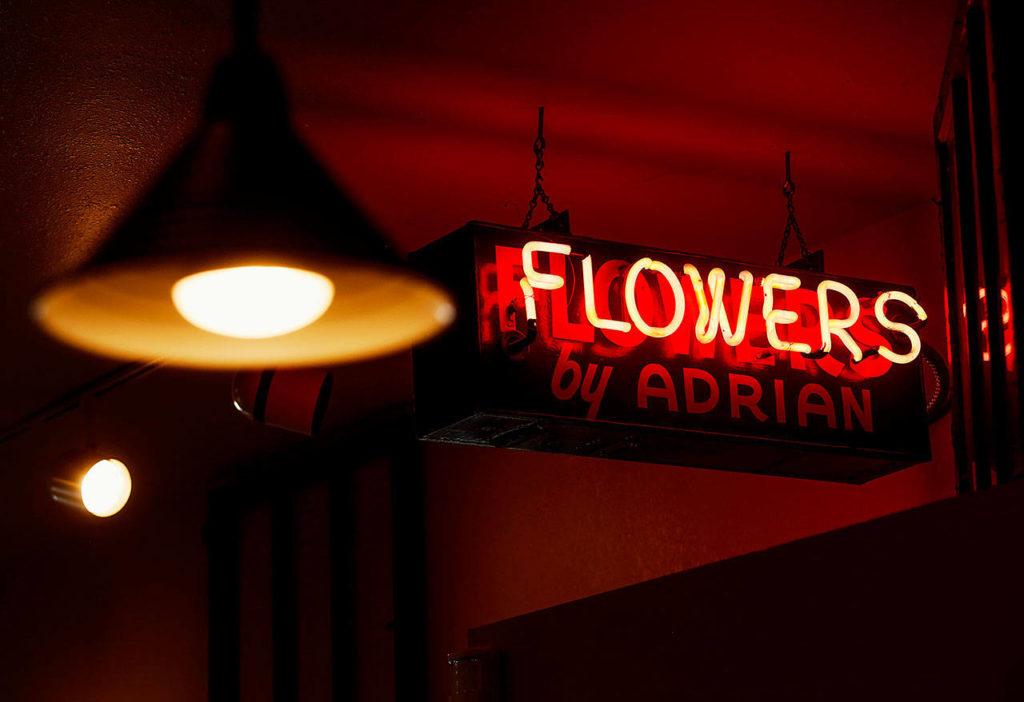 The vintage neon Flowers by Adrian sign that Bob Adrian’s mother, Lorraine, hung on her house years ago when she started the shop, is going home with Bob and Paula Adrian. Bob, who as a child broke the fixture playing ball, will hang it in his own home. (Dan Bates / The Herald)
