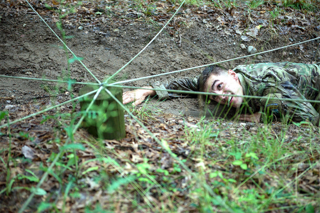 Sgt. Grant Reimers, a heavy vehicle driver with 1859th Light-Medium Transportation Company, Nevada National Guard, moves through the low-crawl obstacle on the confidence course during the 2017 Army National Guard Best Warrior Competition on July 18 at Camp Ripley, Minnesota. This was the fifth event of the day the competitors completed on the second day of the competition. (Minnesota National Guard / Sgt. Sebastian Nemec)
