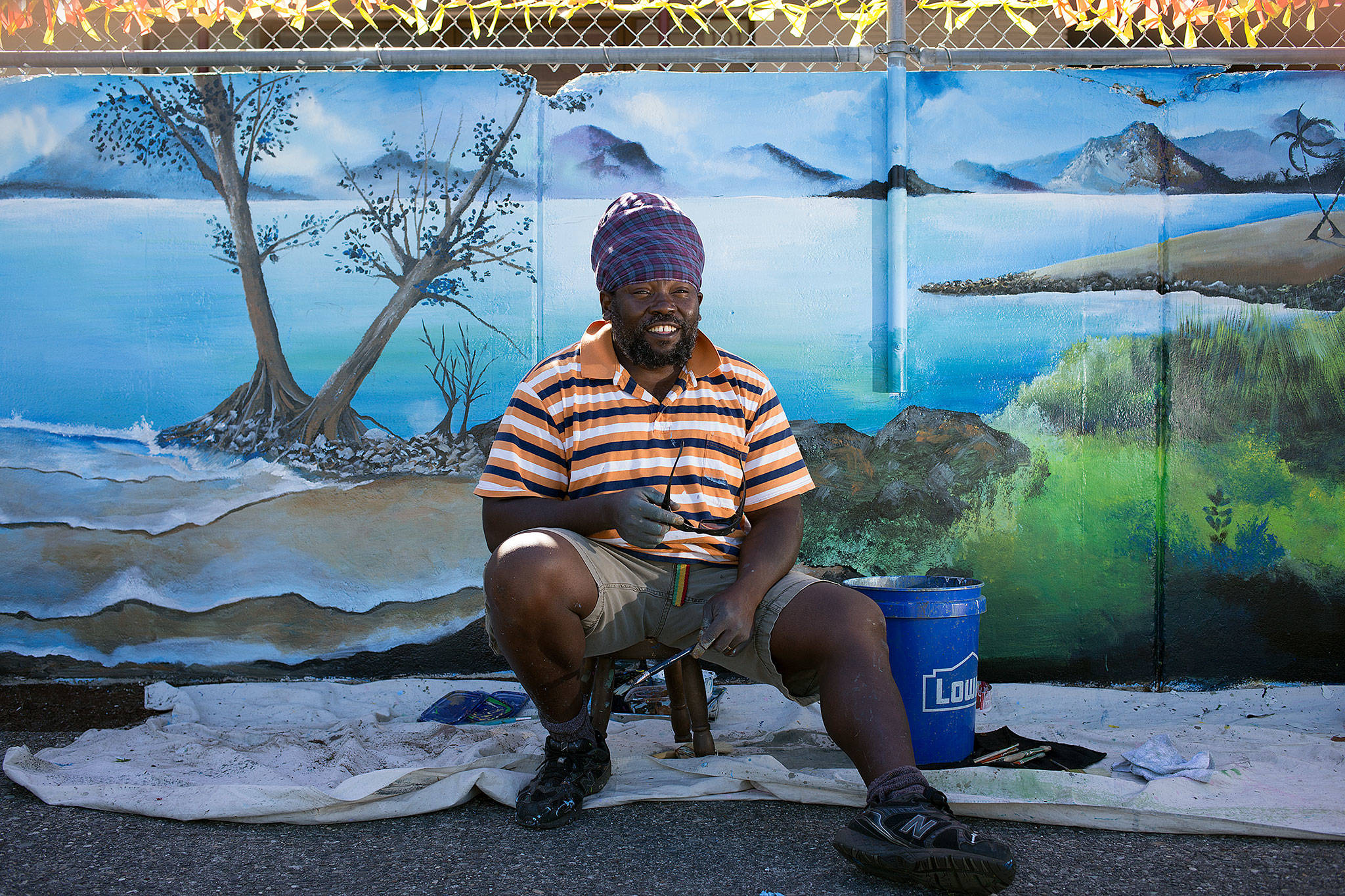 “I didn’t want to do just one tiny section and leave the whole thing empty,” says Nico Gomez while in front of his mural at Lowell Elementary on July 26 in Everett. The Belize native took several weeks off from work to complete the mural with a school mascot leopard theme. (Andy Bronson / The Herald)