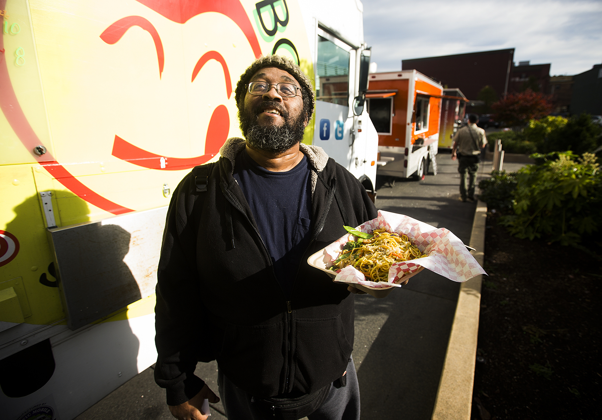 Kevin Hughes stands near the Yummy Box Food Truck after picking up his order of chicken stir fry at last year’s Food Truck Festival. “I got off the bus and my nose led me here,” Hughes said. This year’s festival will have about 25 food trucks at Wetmore Avenue and California Street. (Ian Terry / The Herald)
