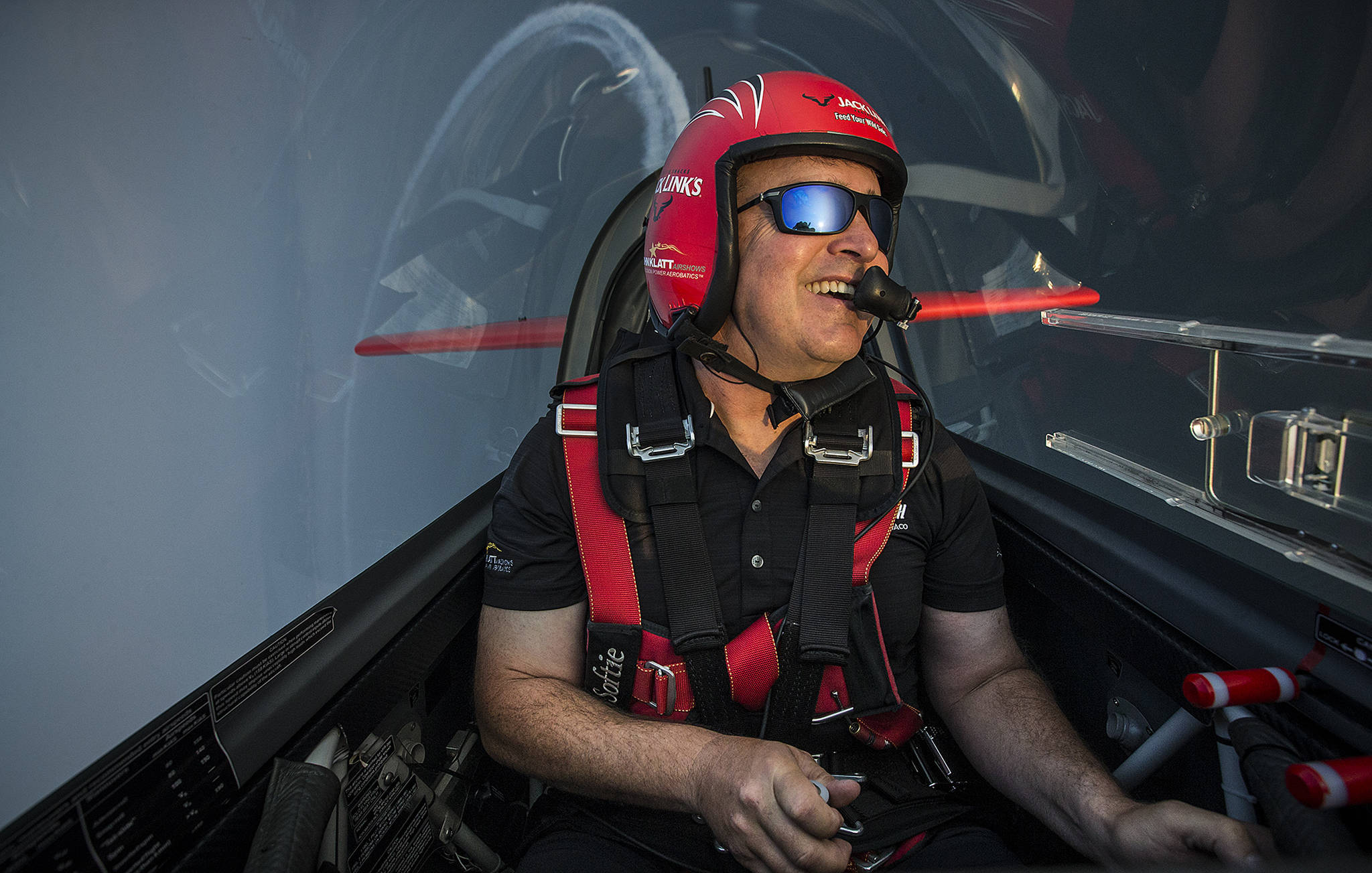 Lt. Col. John Klatt dips his Extra 300L aerobatic plane into a roll while flying over the Puget Sound on Thursday, Aug. 3 in preparation for the annual Seafair show held this upcoming weekend around Seattle. Klatt will be performing stunts in both his Extra 300L and a jet powered biplane dubbed the “Screamin’ Sasquatch” under the Jack Link’s title name for the festival. (Ian Terry / The Herald)