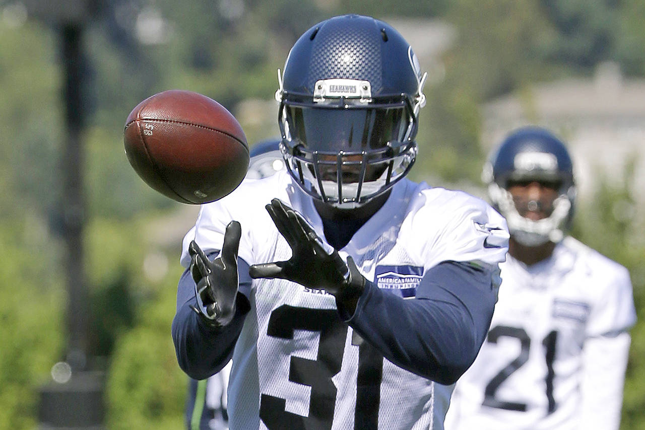 Seattle Seahawks strong safety Kam Chancellor catches the ball during an NFL football training camp Monday in Renton. (AP Photo/Ted S. Warren)