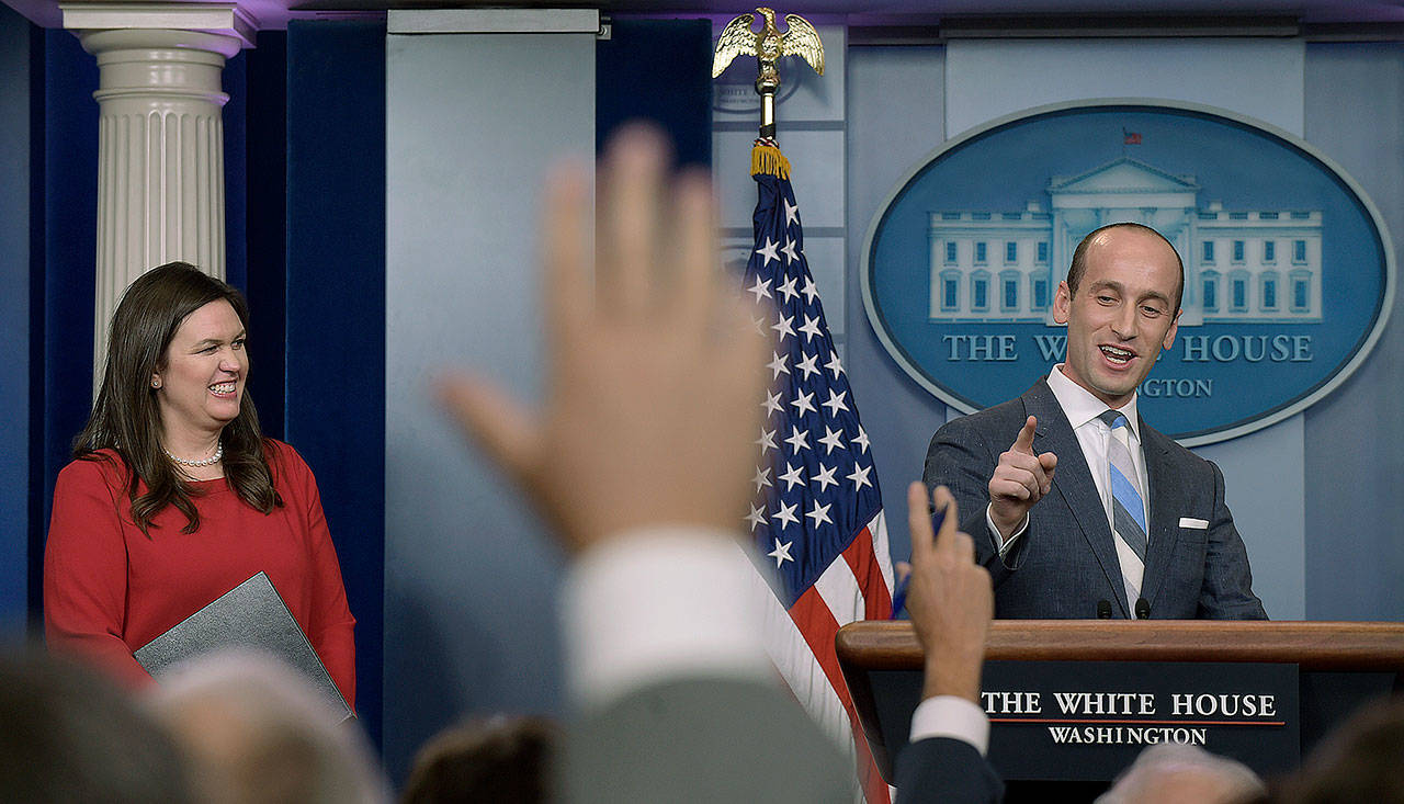 White House press secretary Sarah Huckabee Sanders (left) watches as White House senior policy adviser Stephen Miller calls on a reporter during the daily briefing at the White House in Washington on Wednesday. (AP Photo/Susan Walsh)