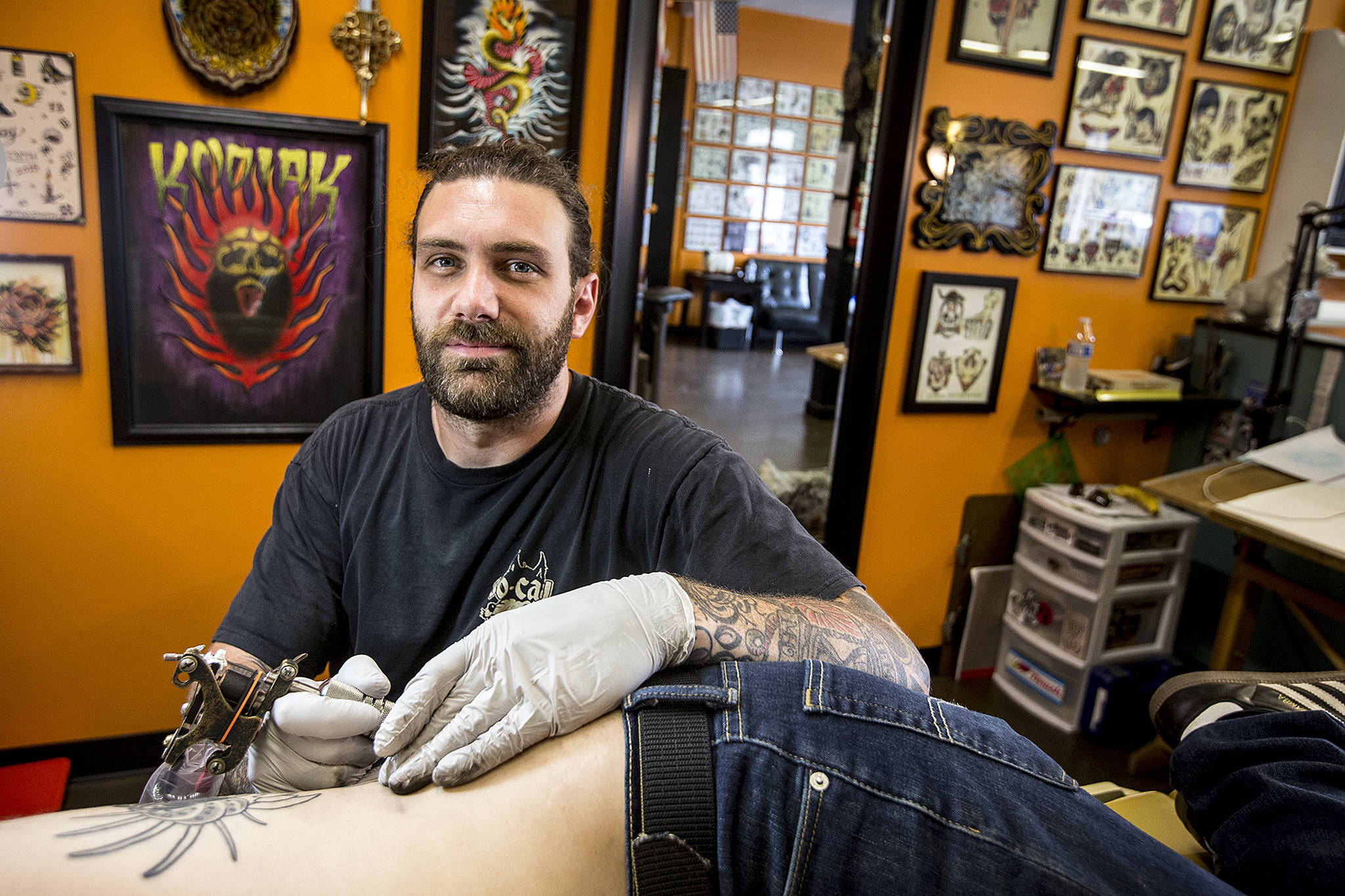 Mike “Kodiak” MacKenzie, owner of Tattoosmith & Piercing in Everett, has been invited back to the Seattle Tattoo Expo for his fourth time. (Ian Terry / The Herald)