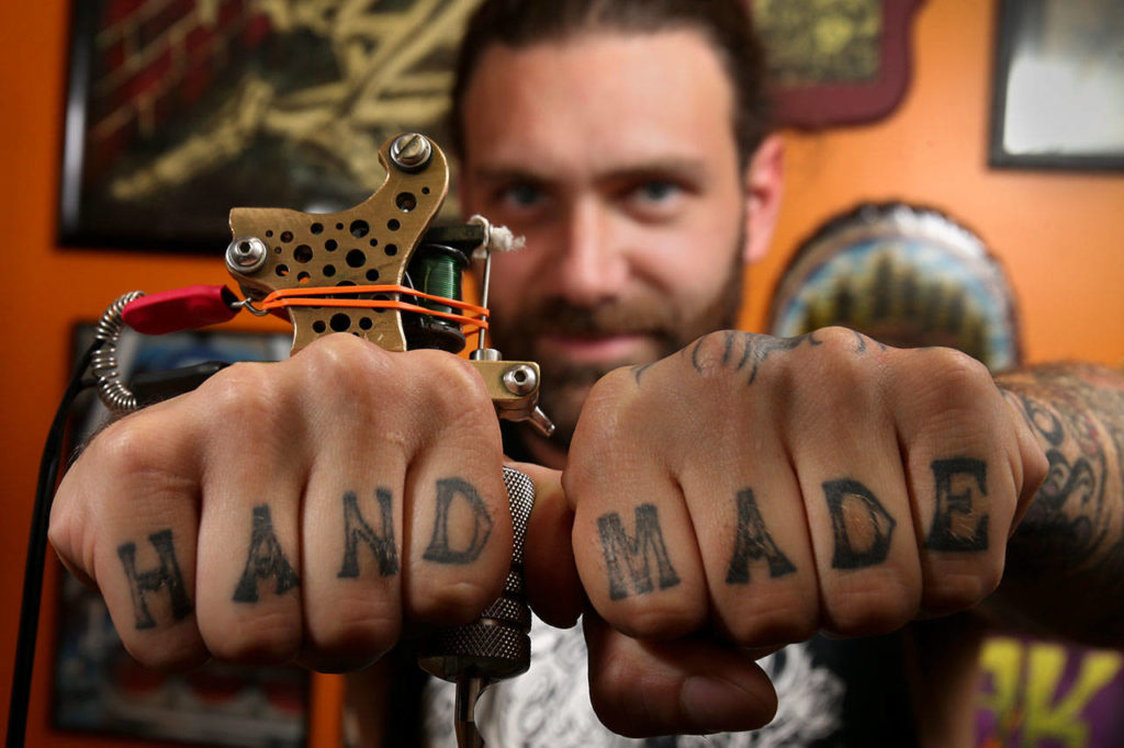 Michael Mackenzie, owner of Tattoosmith & Piercing in Everett. (Kevin Clark / The Herald)
