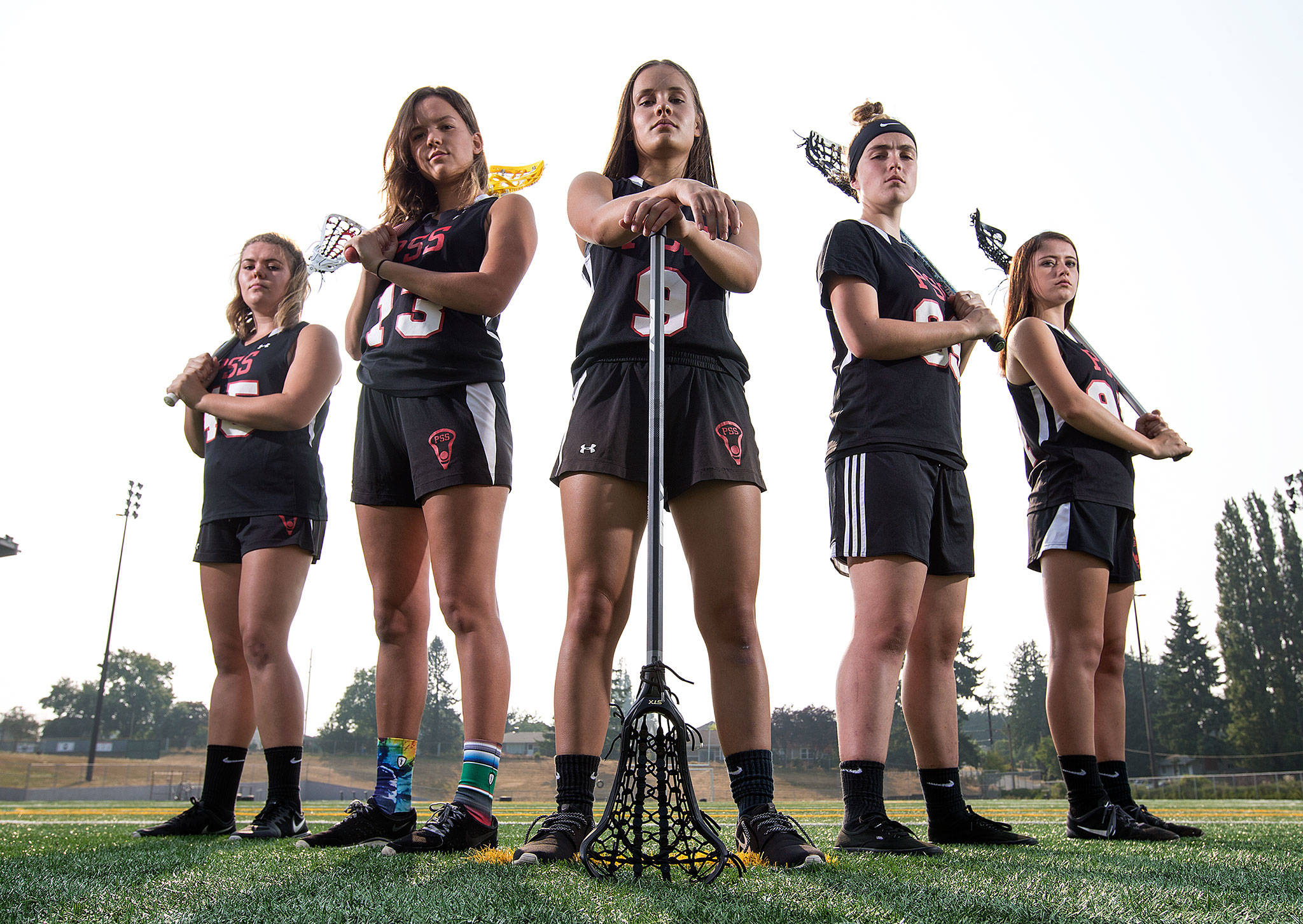 From left, lacrosse players Hailey Carlin, Aenne Thom, Sydney Landdeck, Jordyn Vaughn and Carolynn Barashkoff pose together Tuesday at Snohomish High School. The five Snohomish County residents played in the World Cup Lacrosse Festival, an under-19 tournament with teams from around the world, held in the London suburb of Guildford.