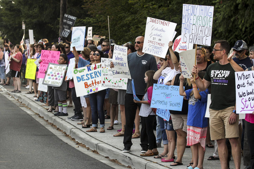 Teachers and parents gather for a rally outside Edmonds School District offices Tuesday evening to highlight ongoing struggles with contract negotiations. (Ian Terry / The Herald)
