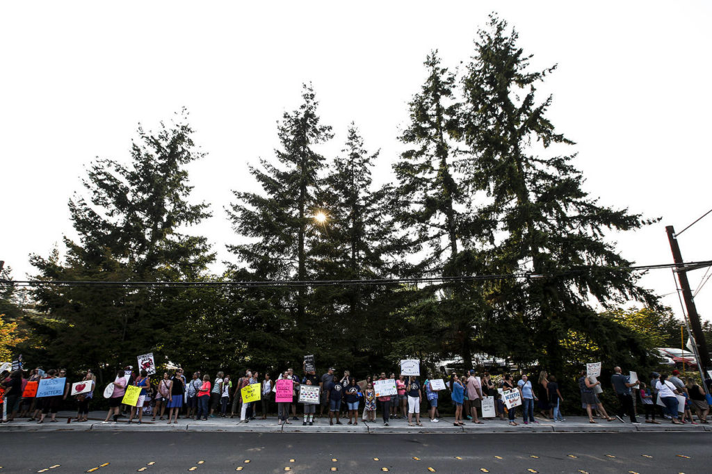 Teachers and parents gather for a rally outside Edmonds School District offices Tuesday evening to highlight ongoing struggles with contract negotiations. (Ian Terry / The Herald)
