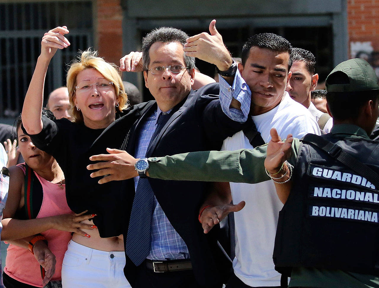 Venezuelan General Prosecutor Luisa Ortega Diaz is surrounded by loyal employees of the General Prosecutor’s office, as she was barred from entering by security forces outside of the General Prosecutor headquarters in Caracas, Venezuela, on Saturday. (AP Photo/Wil Riera)