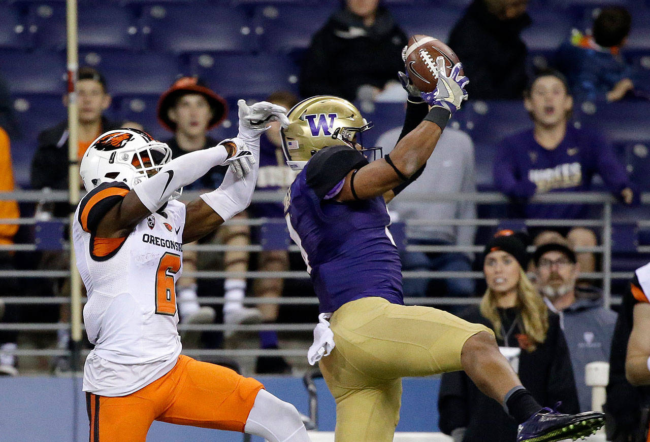 Washington’s Austin Joyner, a Marysville Pilchuck graduate, intercepts a pass meant for Oregon State’s Victor Bolden Jr. in the second half of an Oct. 26, 2016 game in Seattle. (AP Photo/Elaine Thompson)