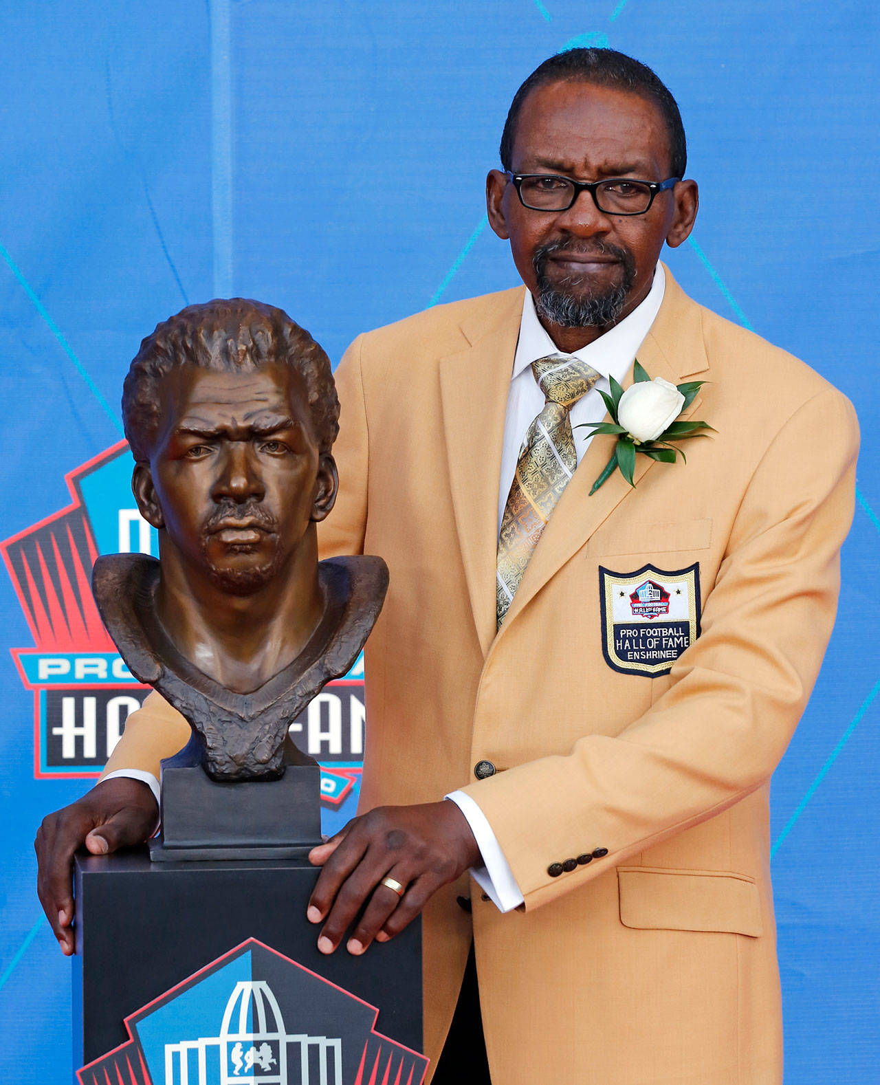 Former Seattle Seahawks player Kenny Easley poses with a bust of himself during an induction ceremony at the Pro Football Hall of Fame on Saturday in Canton, Ohio. (AP Photo/Ron Schwane)