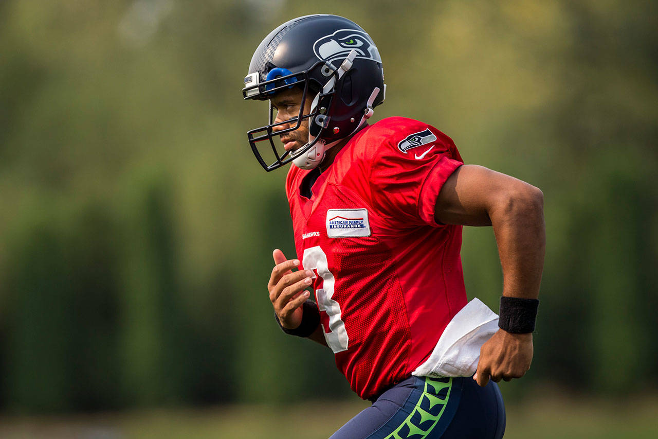Seahawks quarterback Russell Wilson sprints between drills during practice at the Virginia Mason Athletic Center on Aug. 6, 2017, in Renton. (Bettina Hansen/The Seattle Times via AP)