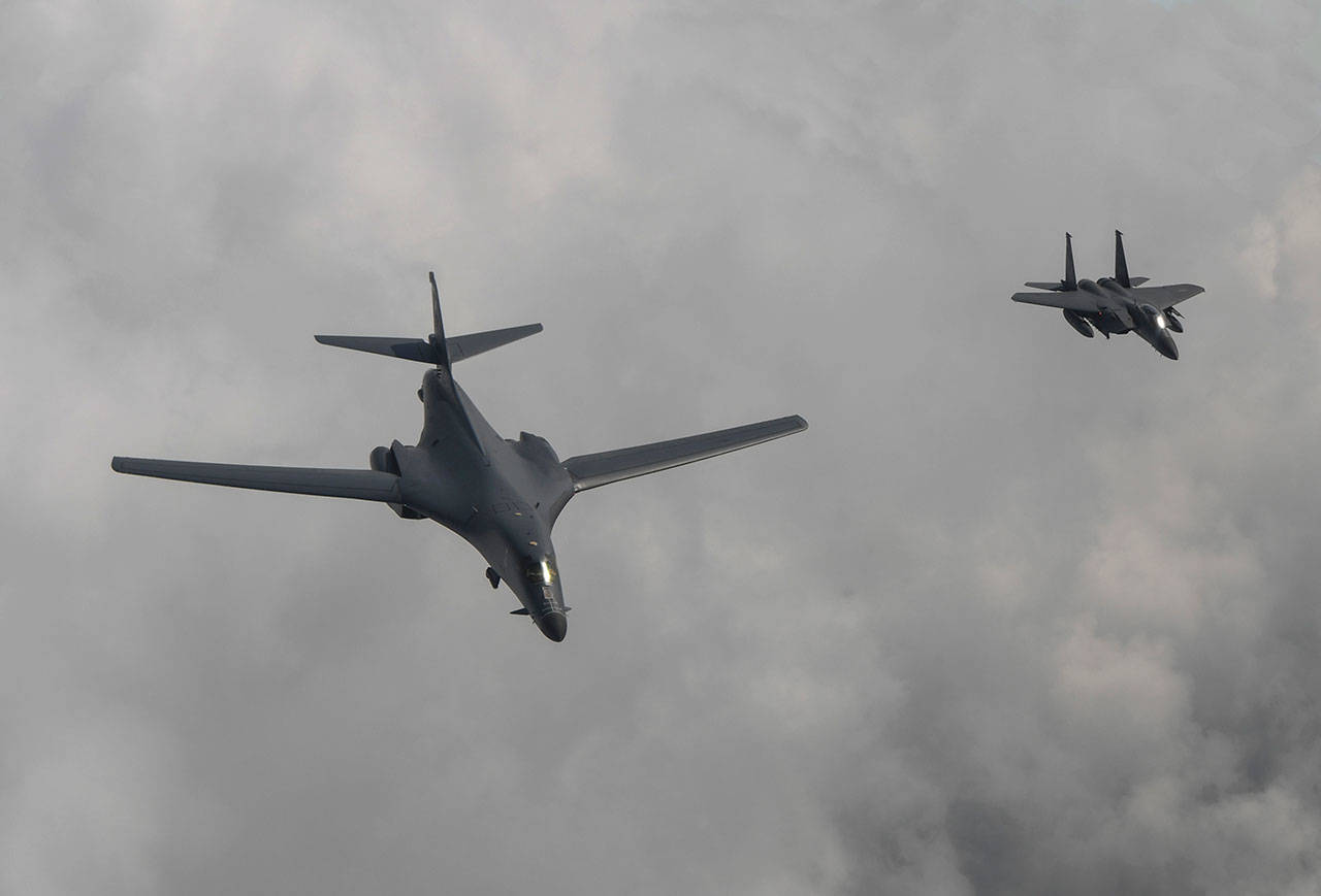 A U.S. Air Force B-1B bomber (left) flies with a South Korean fighter jet over the Korean Peninsula on July 30. The United States flew two supersonic bombers over the Korean Peninsula in a show of force against North Korea after the country’s latest intercontinental ballistic missile test. (South Korea Defense Ministry via AP)