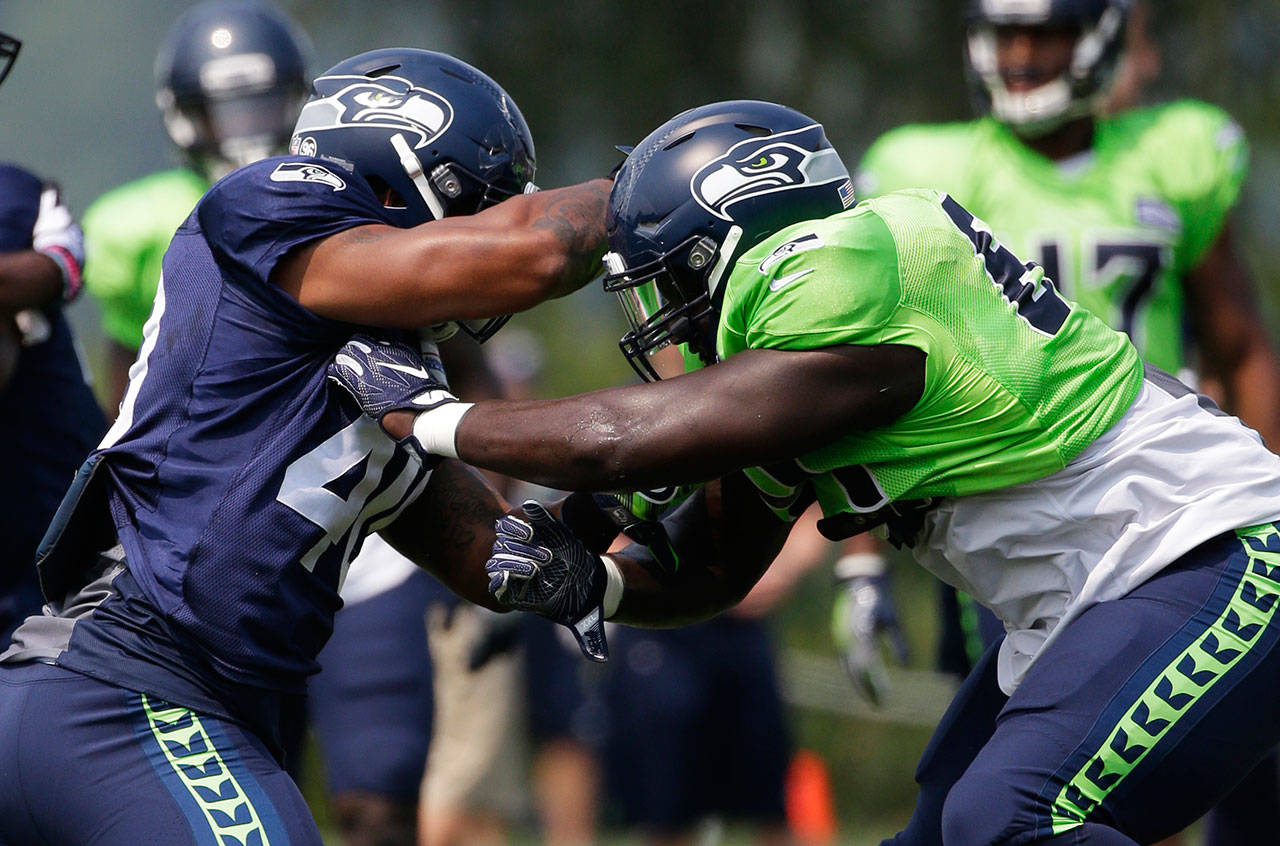 Seahawks defensive tackle Rodney Coe (right) blocks fullback Kyle Coleman during a drill on Aug. 7, 2017, in Renton. (AP Photo/Ted S. Warren)