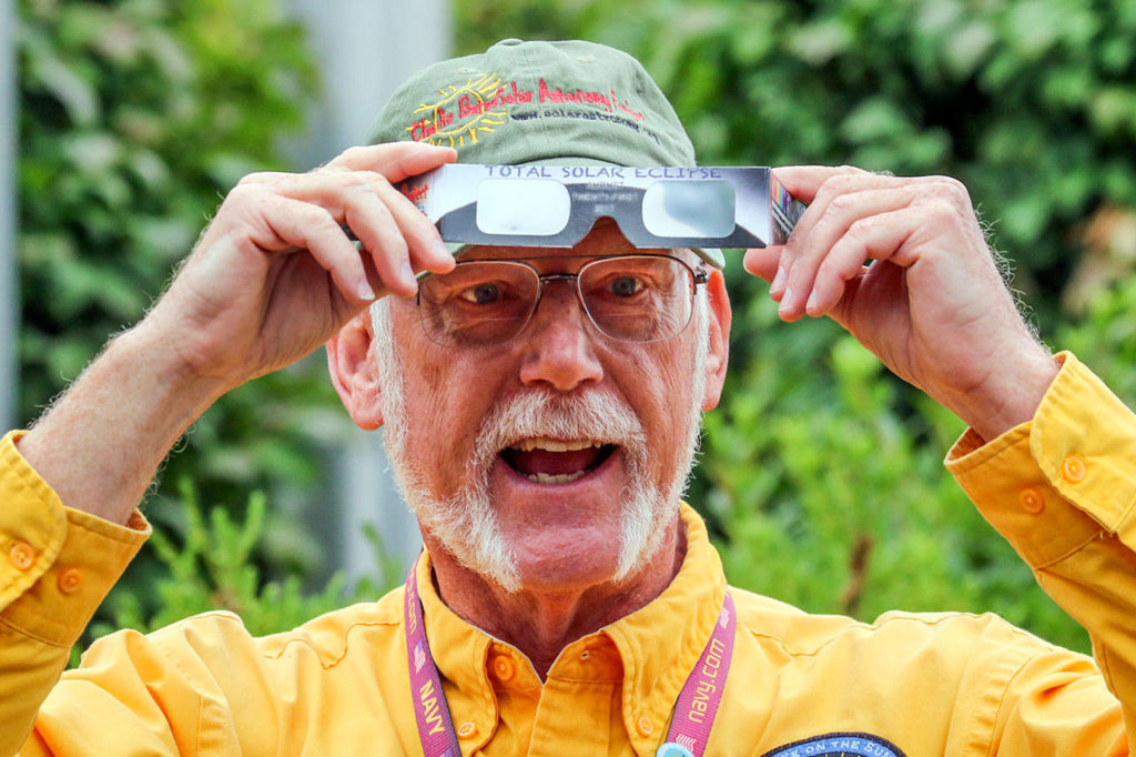 Roger Kennedy demonstrates the proper use of solar viewing shades Thursday afternoon at Lake Stevens Community Center on July 27, 2017. (Kevin Clark / The Herald)
