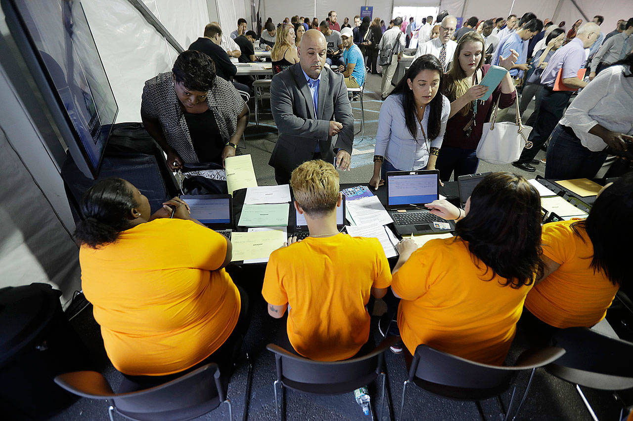 Candidates are processed during a job fair at the Amazon Fulfillment center in Robbinsville Township, New Jersey, last week. (AP Photo/Julio Cortez)