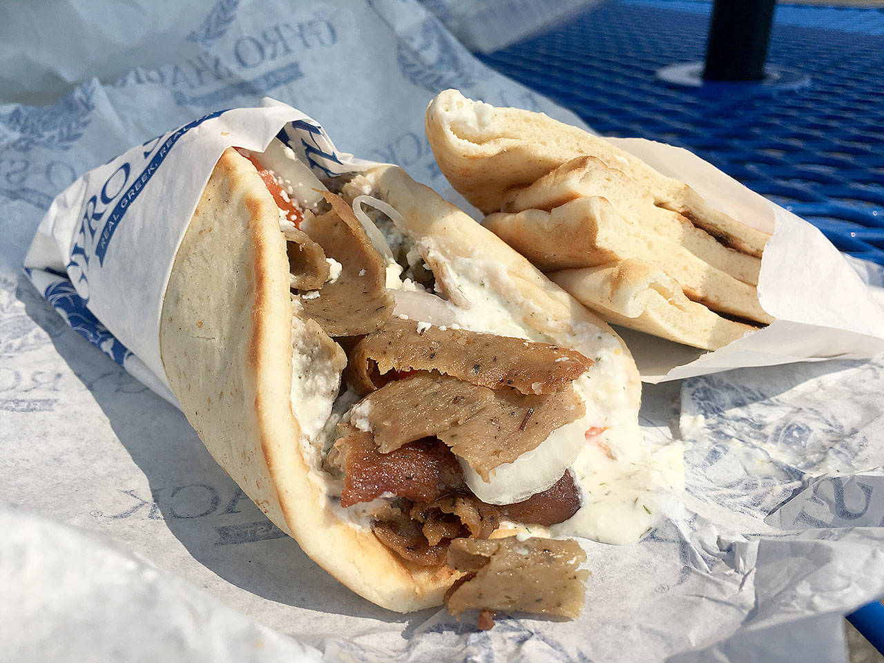 Gyro Shack’s Deluxe gyro with gyro meat, an 80/20 percent beef/lamb mix of seasoned and spiced meats with tzatziki sauce, onions and feta cheese, with a combo addition of pita bread and more tzatziki sauce. (Ben Watanabe / The Herald)