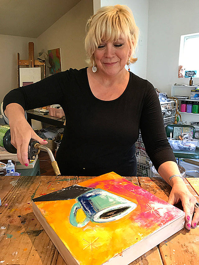 Machias artist Jackie Cort demonstrates her encaustic work with colored bees wax. Cort is the poster artist for this year’s Schack Art Center Fresh Paint Festival of Artists at Work. She also will be demonstrating her work Aug. 19 and 20 at the festival in Everett. (Gale Fiege / The Herald)