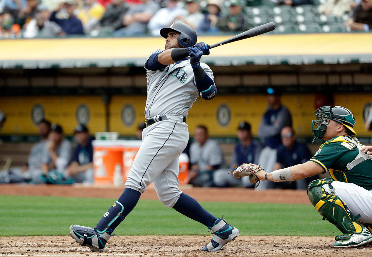 The Mariners’ Nelson Cruz follows through on his two-run home run against the Athletics during the third inning of a game Aug. 9, 2017, in Oakland, Calif. (AP Photo/Marcio Jose Sanchez)