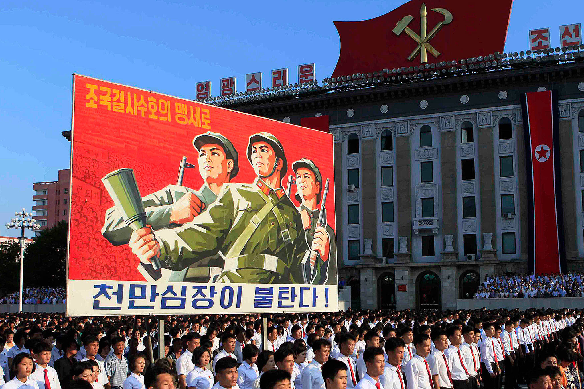 North Koreans gather for a rally at Kim Il Sung Square carrying placards and propaganda slogans as a show of support for their rejection of the United Nations’ latest round of sanctions Wednesday in Pyongyang, North Korea. (AP Photo/Jon Chol Jin)