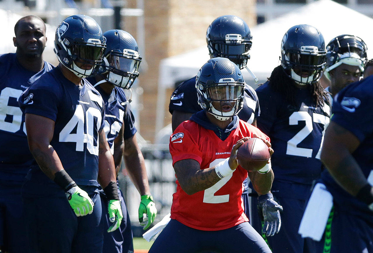 Seattle quarterback Trevone Boykin holds a football during a July 31 training camp session in Renton. (AP Photo/Ted S. Warren)