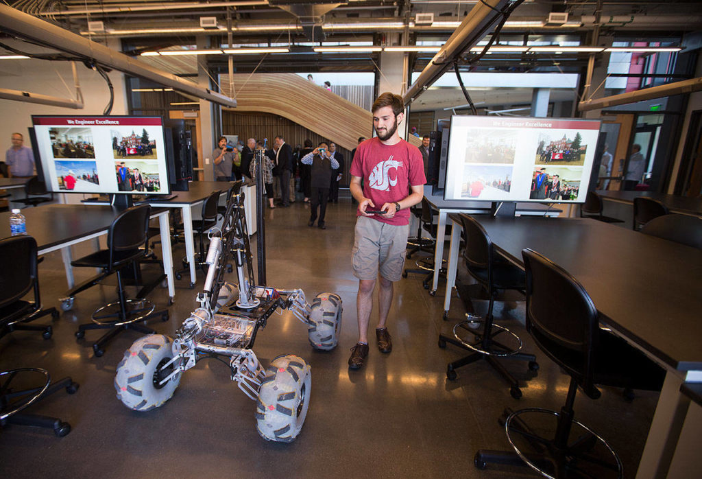 Alden Wester drives a Mars Rover out of the building before the ribbon-cutting ceremony at the Washington State University Everett building on Tuesday. Wester will be the Mars Rover Team Lead next year. (Andy Bronson / The Herald)
