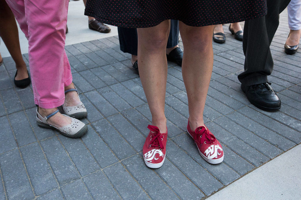 Brigitte Bolerjack wears Cougar logo shoes, which she hand drew on her shoes, while attending the ribbon-cutting ceremony at the Washington State University Everett building on Tuesday. (Andy Bronson / The Herald)
