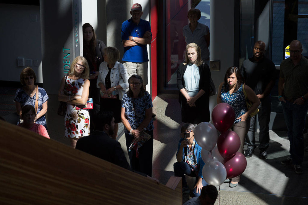 Guests listen as they begin a tour during an open house and ribbon-cutting ceremony at the Washington State University Everett building on Tuesday. (Andy Bronson / The Herald)
