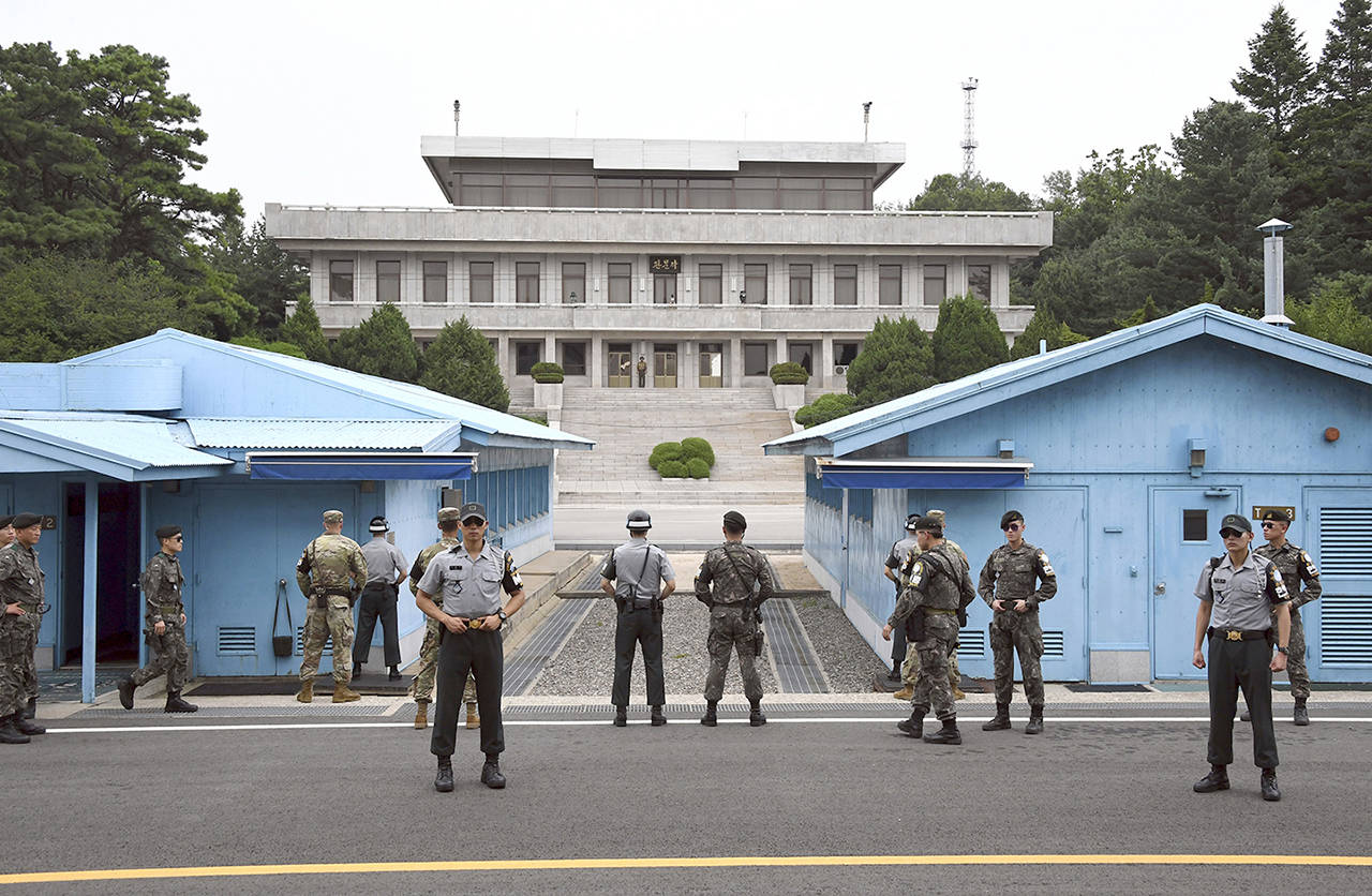 In this July 27 photo, South Korea and U.S. soldiers stand guard during a commemorative ceremony for the 64th anniversary of the signing of the Korean War Armistice Agreement at the truce village of Panmunjom in the Demilitarized Zone (DMZ) dividing the two Koreas. (Jung Yeon-Je/Pool Photo via AP, File)