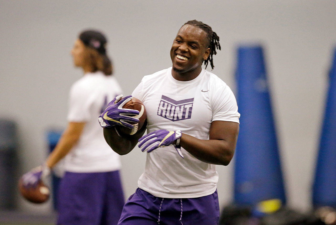 Washington tailback Lavon Coleman smiles during a drill at the team’s first official practice of the year on July 31 in Seattle. (AP Photo/Elaine Thompson)