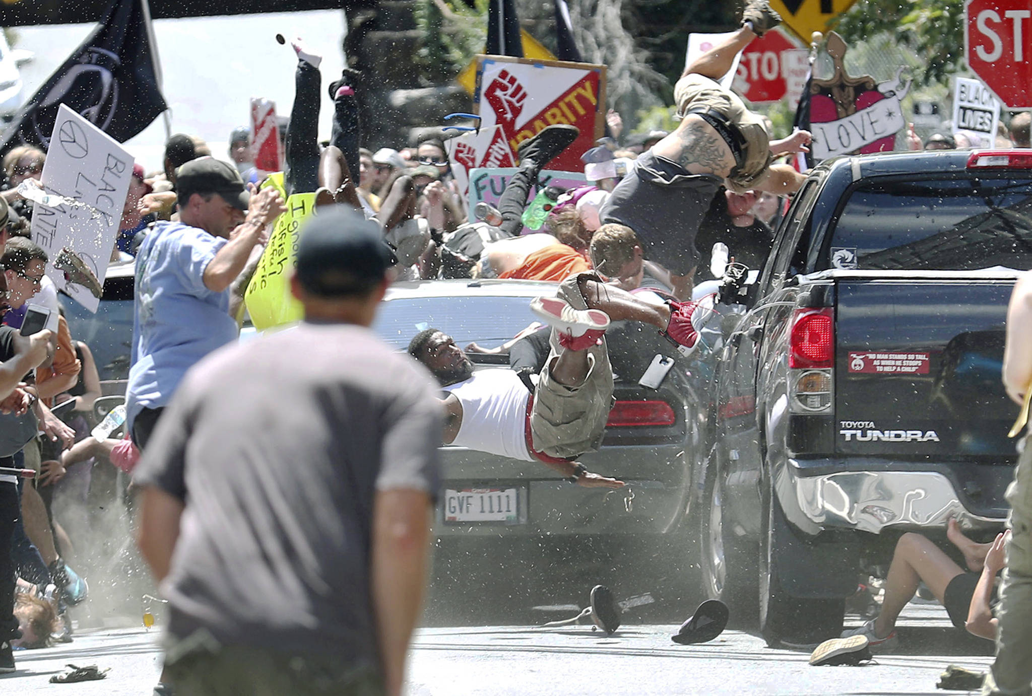 People fly into the air as a vehicle drives into a group of protesters demonstrating against a white nationalist rally in Charlottesville, Virginia, on Saturday. (Ryan M. Kelly/The Daily Progress via AP)